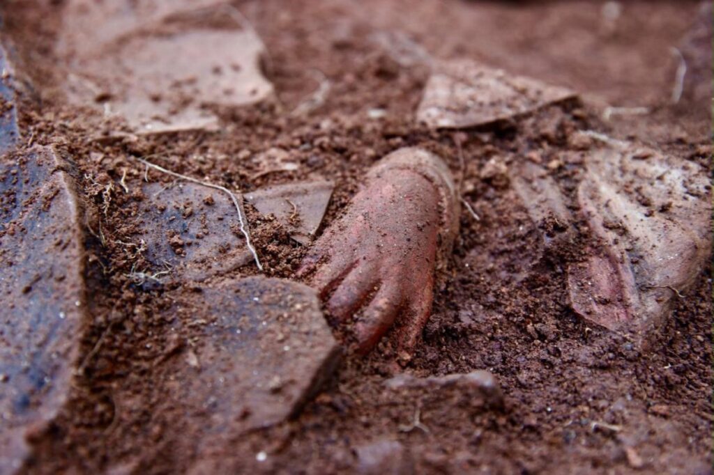 Terracotta hand and pottery fragments found in the soil during excavations at Kurul Castle in Türkiye.