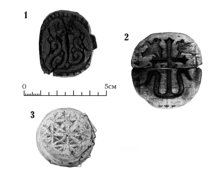 Medieval wooden bread stamps decorated with Christian crosses, recovered from archaeological sites in Novgorod.