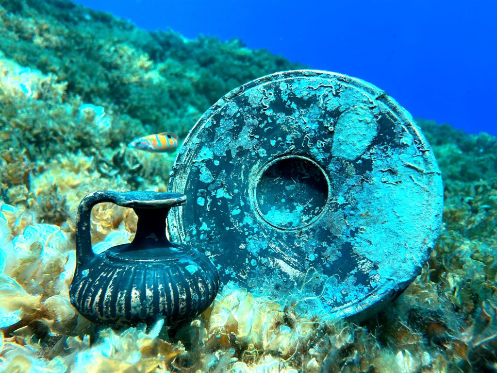 Ancient black-glazed pottery, including a small jug and a plate, discovered at the Hellenistic shipwreck site off Croatia.