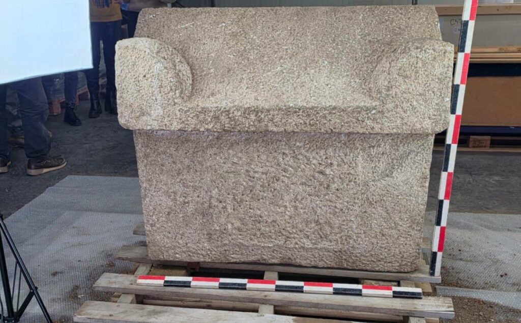 Rectangular Roman stone sarcophagus with its heavy carved lid.