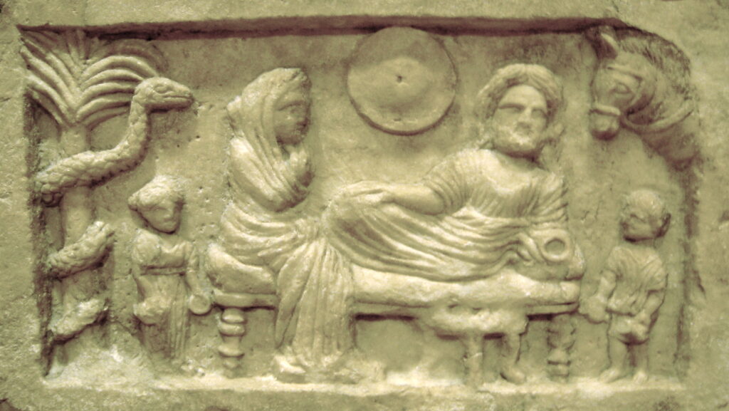 Ancient Roman funerary relief showing a seated family at a funerary banquet, with a small figure of Asklepios suspended from a tree.