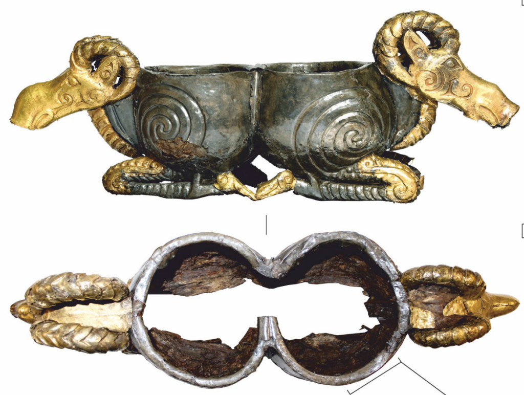 Top-down view of the Sarmatian gold and silver vessel from Filippovka 1, clearly showing its figure-eight shape with opposing mountain goat and ram heads.