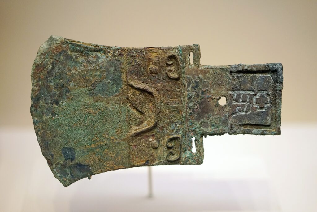 Shang Dynasty bronze ge dagger-axe bearing the inscription “Ya Qi,” discovered in the 3,200-year-old tomb of Fu Hao at Yinxu, China.
