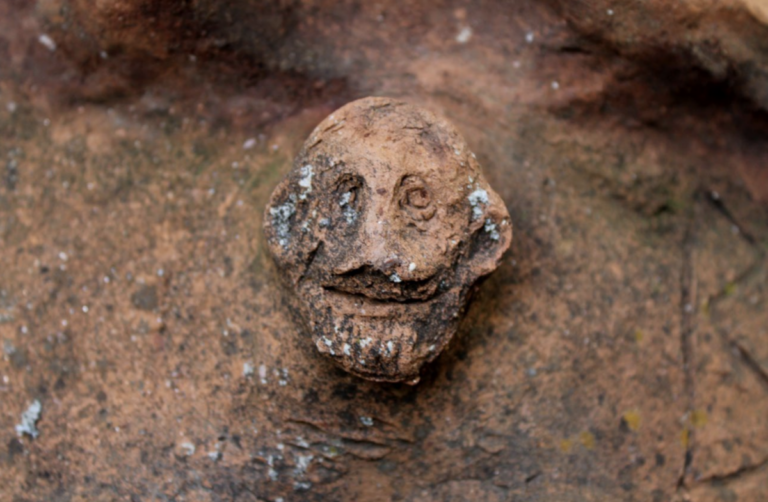Close-up of a terracotta Silenus head and workshop mark on a Roman-era sarcophagus lid discovered at Attouda in western Türkiye.