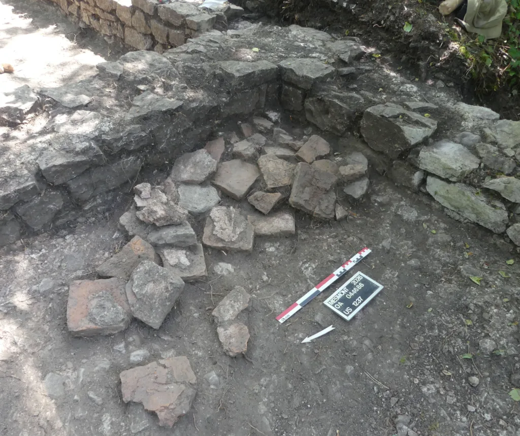 Small hypocaust pillars and fragments of raised flooring discovered inside an early medieval building at Montagne de Saint-Laurent, France.