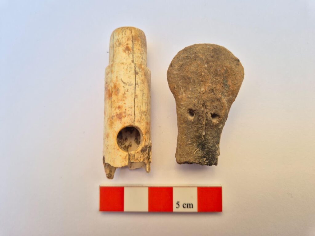 Bone flute and anthropomorphic idol head discovered at Troy during the 2026 excavation season in Türkiye.