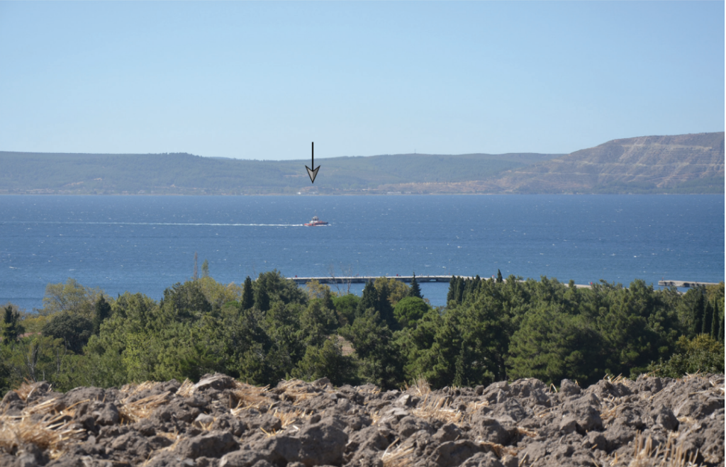 View across the Dardanelles from Yaylatepe Höyük toward Asartepe on the Gallipoli Peninsula, marked by an arrow.