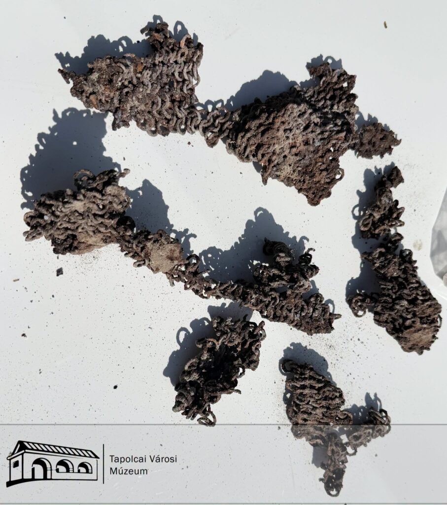 Sections of medieval-style iron chain mail recovered during archaeological excavations at Szigliget, Hungary.