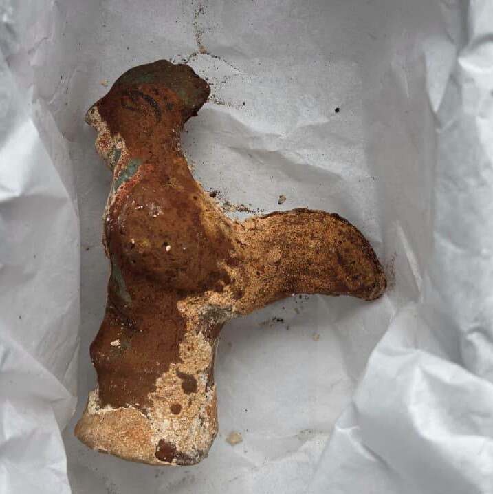 Ancient Roman terracotta rooster-shaped rattle with traces of painted decoration.