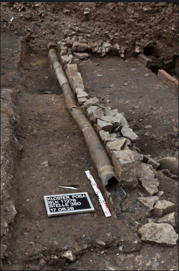 The course of the 14th-century clay water pipeline after the overlying roof tiles, which protected the pipes from damage, were removed. 