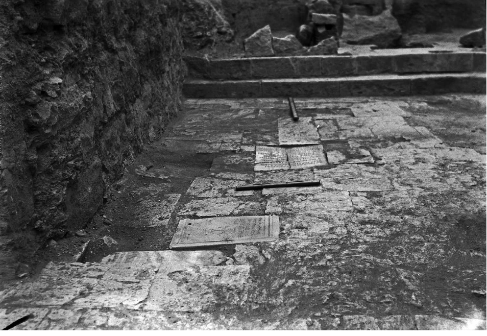 Archival photograph showing tombstones embedded in the floor of Shivta's Byzantine baptistery during excavations in the 1930s.