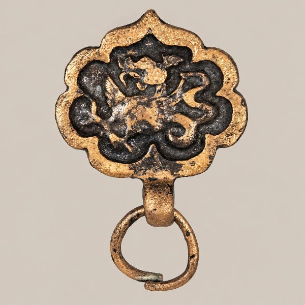 Medieval bronze belt fitting with a fantastical animal motif and circular hanging ring, discovered at the Troitsky XVII excavation in Veliky Novgorod.